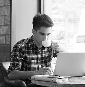 The guy is working and drinks coffee